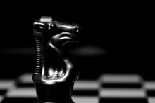 Close Up Of Chess Pieces On A Reflective Mirror Board Surface With Black Background