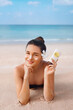 Beauty Woman in Bikini Holding Bottles of Sunscreen in Her Hands. Skincare. A Beautiful Female Applying Sun Cream. Using Sun protection. Girl  smear moisturizing lotion on skin. Suntan