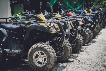 View of row dirty ATVs quad bike