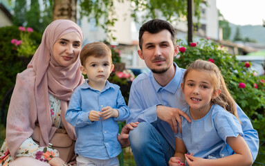 Portrait of a happy young Muslim family outdoor.