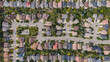 Top down aerial view of houses and streets in beautiful residential neighbourhood in Calgary, Alberta, Canada, properties, homes and real estate concept, summer season. 