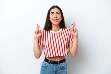 Young caucasian woman isolated on white background with fingers crossing and wishing the best