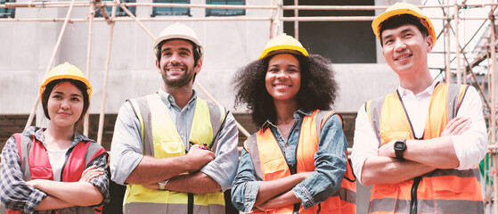 Architecture engineering teamwork meeting at workplace concept. engineer architect wearing safety helmet meeting at contruction site. working contruction on site plans to build high-rise buildings.