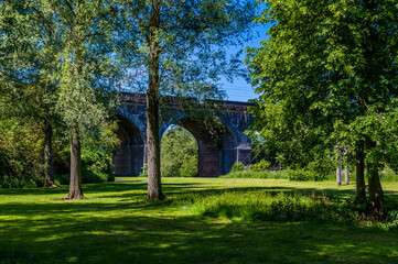 Wall Mural - A view through trees towards the fourteen arches viaduct at Wolverton, UK in summertime