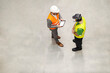 Top view of a storage worker having conversation with supervisor.