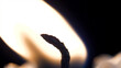 Candle flame closeup over black - Christmas. Candle is lit on a black background closeup. Brightly burning candle macro