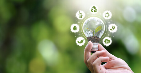 esg banners - environment, society and governance hand holding light bulb with renewable energy icon