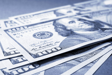 Wall Mural - american paper money. several one hundred dollar bills lie on textured surface. focus on the number 