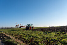 Tractor Ploughing A Field In Winter, France