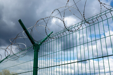 Barbed wire fence with the sky in the background.