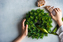 Overhead View Of A Boy Holding Gingerbread Cookies And A Christmas Wreath