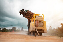 Construction Worker Using Road Cutting Machinery To Cut Road Surface, Thailand