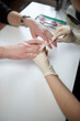 © Alenka - Manicurist makes a manicure for a man. Male manicure.