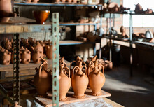 Different Ceramic Products On Racks In Pottery Workshop