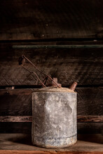 Old Galvanized Water Or Gas Can Sits On A Shelf In Shed