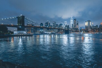 Wall Mural - Brooklyn Bridge at Night with Water Reflection in New York City