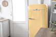 © Pixel-Shot - Yellow vintage fridge in interior of kitchen