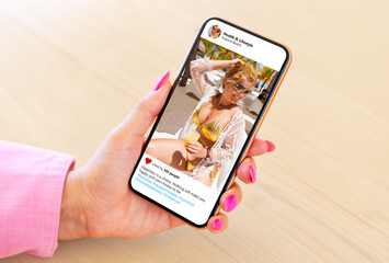 Wall Mural - woman looking at someone's vacation photo shared on sample social media app