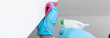 © Puwasit Inyavileart - Employee's hands were wiping the white walls, use a towel moistened with cleaning solution to rub the wall, Text fill area, White background, Eliminate germs during the virus outbreak.