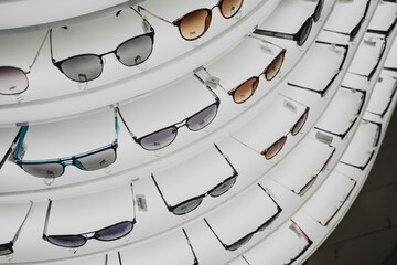 Rows of sunglasses on the counter of an optical store