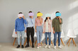 © Studio Romantic - Group of five young people standing in a row and holding message bubbles. Team of men and women sharing different opinions anonymously as they are hiding their faces behind mock up speech balloons