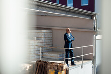 Businessman Standing With Arms Crossed At Construction Site