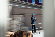 Senior Businessman Standing At Construction Site