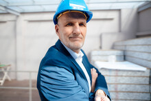 Businessman With Arms Crossed At Construction Site
