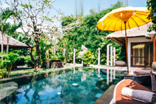 Indonesia, Bali, Defocused View Of Poolside Of Luxurious Villa In Summer