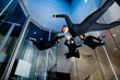 © Westend61 - Athletes holding each others hands flying in wind tunnel