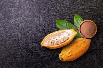 Wall Mural - Cocoa powder in wooden bowl and fresh yellow cocoa fruit with cut in half sliced and green leaf isolated on white background. Top view. Flat lay.