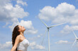 © Antonioguillem - Woman breathing fresh air in a wind farm