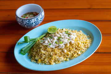 Wall Mural - Cuisine and Food, Plate of Crab 
Fried Rice Served Usually Served with
 Cucumber Slice and Spicy Sauce.