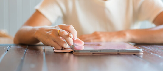 woman using tablet for sms messages, hand holding pencil typing touchscreen mobile phone in cafe or modern office. lifestyle, technology, Social media and network concept