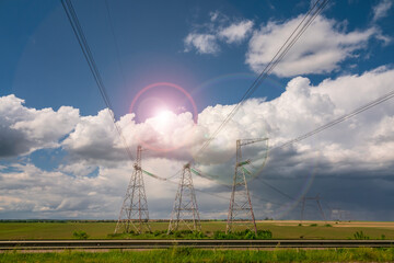 Wall Mural - Power lines against the blue sky with clouds