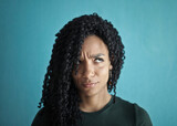 Fototapeta  - pensive young woman on blue background