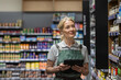 © ReeldealHD images - Small business owner of a food market stock taking with a digital tablet