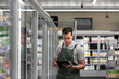 © ReeldealHD images - Employee of a food market stock taking with a digital tablet