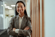 Portrait Of Attractive Asian Business Woman Standing In Modern Office And Looking Camera