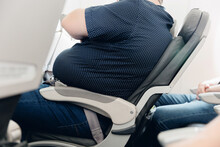 Fat Obese Man Passenger Fastening Seat Belt On Airplane, Problem Safe Flight