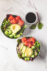 Wall Mural - Hawaiian poke - brown rice, salmon, edamame, cucumber and avocado in gray bowl, marble background. Fish fresh salad for a healthy diet.