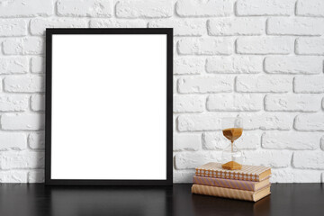 Poster - Books with picture frame on wooden table