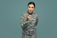 Young Military Servicewoman Pointing At The Camera In A Studio