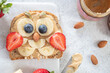 © azurita - Kids breakfast or lunch or snack toast with peanut butter spread, banana, strawberry and blueberry shaped as cute owl.