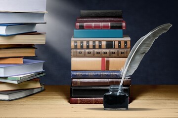 Wall Mural - old books and a fountain pen in an inkwell. concept on the theme of history, nostalgia, culture.