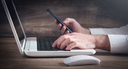 Sticker - Businessman using smartphone and working on laptop.