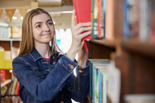 Young Woman Or Student Browsing Books In Book Store