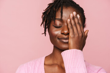 Wall Mural - Black young woman with dreadlocks smiling and covering her eye