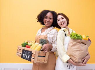 Portrait smiling happy Partner African woman Agricultural business owner holding wooden basket fruit vegetable.The opening of an American business woman's Delivery Organic food  shop.Brazilian female.