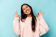 © Asier - Young hispanic woman isolated on blue background cheerful and confident showing ok gesture.